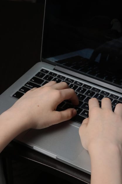 Close-up of hands working on a modern laptop with code visible on the screen, reflecting the technological innovation supported by the state subsidies. A focus on the hands to emphasize action and creation.