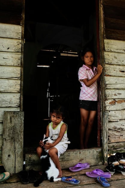 A vibrant and hopeful photograph of a family, internally displaced due to the armed conflict in Colombia, receiving the keys to their new house as part of a government housing assistance program.