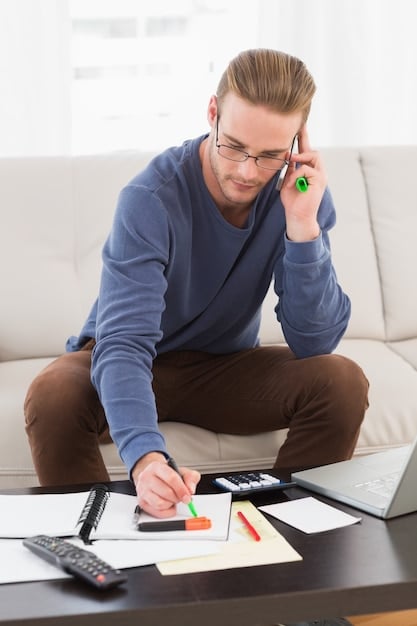 A person reviewing financial documents with a calculator and pen, emphasizing budget assessment and financial planning.