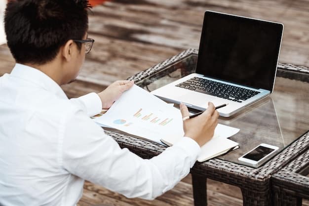 A person using a laptop to compare interest rates and loan terms on different financial websites, focusing on research and comparison.