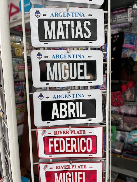 A variety of Colombian car dealership signs are visible. The image should be brightly lit and emphasize choice.