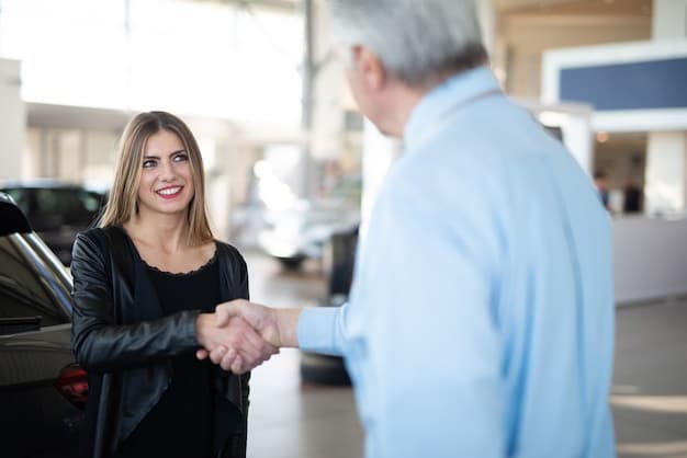 Two people shaking hands over a car in a dealership. The focus is on the handshake, symbolizing agreement and trust in the car buying process.