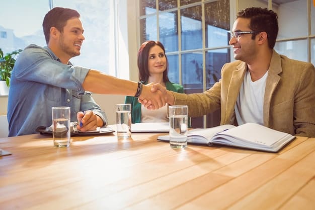 A person shaking hands with a bank representative over a table with loan agreement documents. The atmosphere is professional and positive.