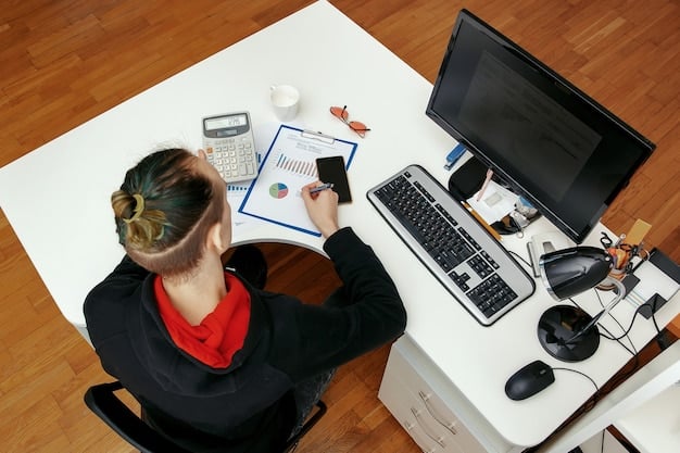 A person sitting at a desk, working on a laptop, surrounded by financial documents and a calculator. The scene is set in a modern home office in Colombia, with natural light streaming through the window. This represents the planning and calculation involved in pension savings for independent workers.