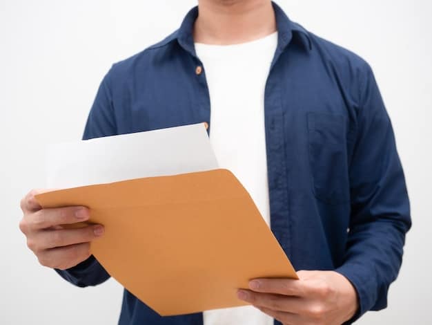 A hand holding a document with the 