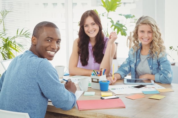 A group of diverse people sitting around a table in a bright office, with a friendly advisor explaining financial options using a tablet. Papers and brochures are scattered on the table, suggesting a detailed discussion about loans and investment plans.